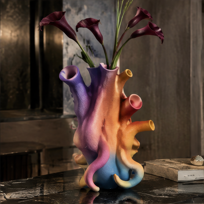 Overhead scene of multi-opening gradient vase with calla lilies and dark marble — artisan design lifestyle shot
