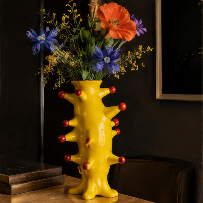 A Masterpiece of Color — overhead view of yellow vase with red ball studs and orange poppy and blue flower arrangement