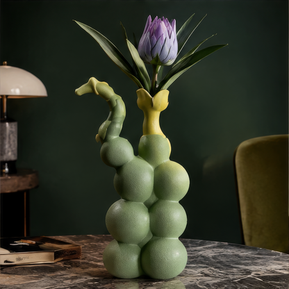 More Than a Vase — sage green bubble sphere vase with yellow rim on marble table in luxury green interior with purple protea