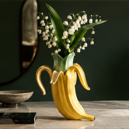 Nature in a More Playful Form — close-up of yellow ceramic banana peel and green interior sleeve with lily of the valley