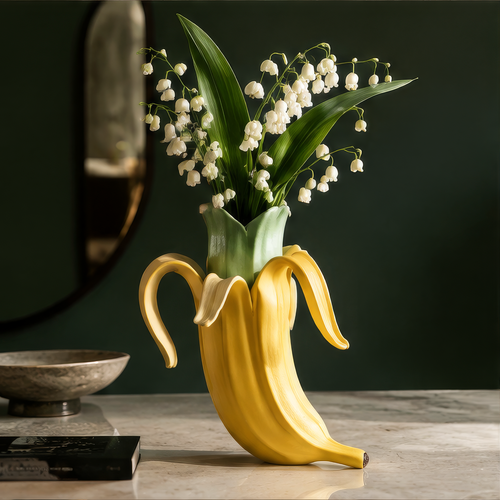 Nature in a More Playful Form — close-up of yellow ceramic banana peel and green interior sleeve with lily of the valley
