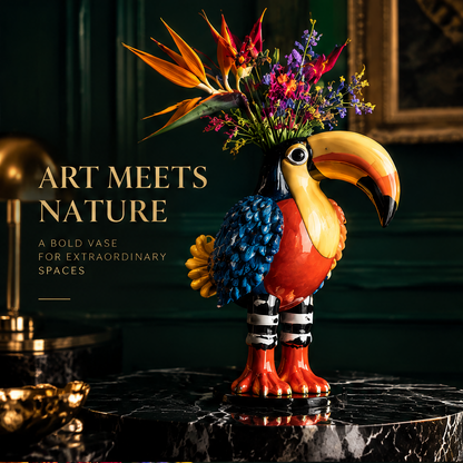 Toucan bird vase with striped legs and vibrant ceramic glaze on black marble with Bird of Paradise and wildflower bouquet