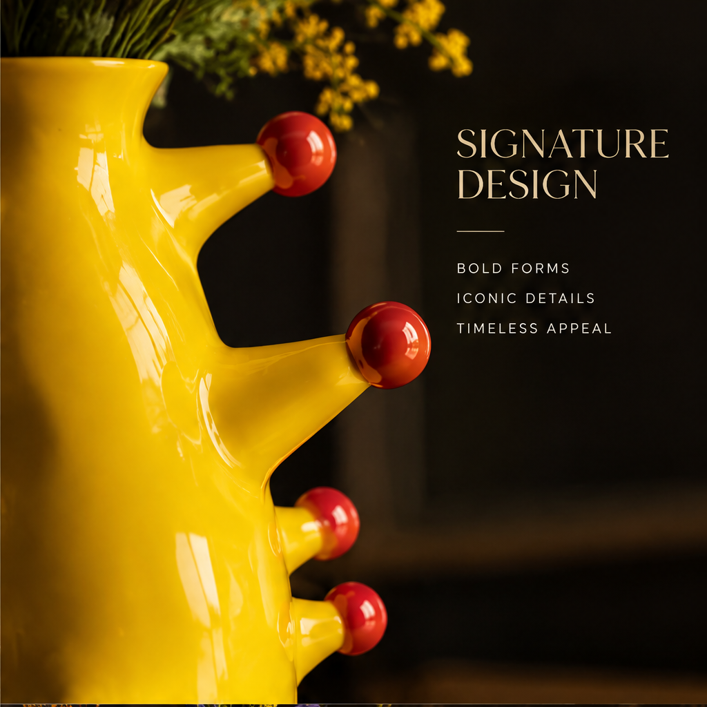 Bold Art For Modern Spaces — yellow trunk vase with red ball studs on black marble with vibrant flower arrangement
