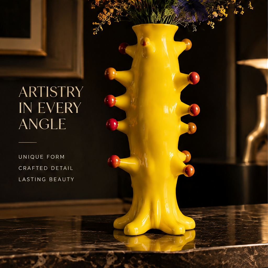 Signature Design close-up — glossy red ball studs on yellow ceramic trunk vase showing bold forms and iconic details